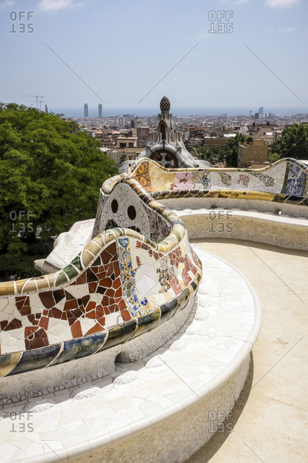 Barcelona, Spain - May 27, 2015: The Park Guell is an Antoni Gaudi-designed public park system composed of gardens and architectonic elements located on Monte Carmelo in Barcelona. Here the curved serpentine bench made out of ceramics