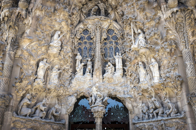 Barcelona, Spain - May 26, 2015: The Sagrada Familia is a large Roman Catholic church in Barcelona, designed by Catalan architect Antoni Gaudi. Religious sculptures are part of the decoration over the entrances