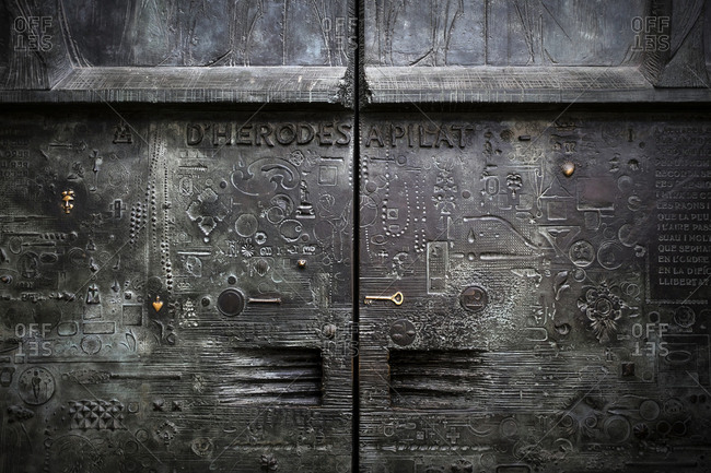 Barcelona, Spain - May 26, 2015: The Sagrada Familia is a large Roman Catholic church in Barcelona, designed by Catalan architect Antoni Gaudi. Here religious typography on the metal doors