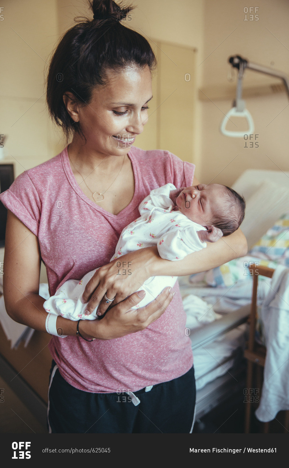Happy mother holding her newborn baby in hospital