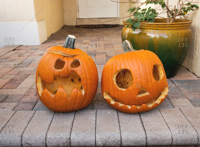 Rotting Halloween pumpkins on a house stoop