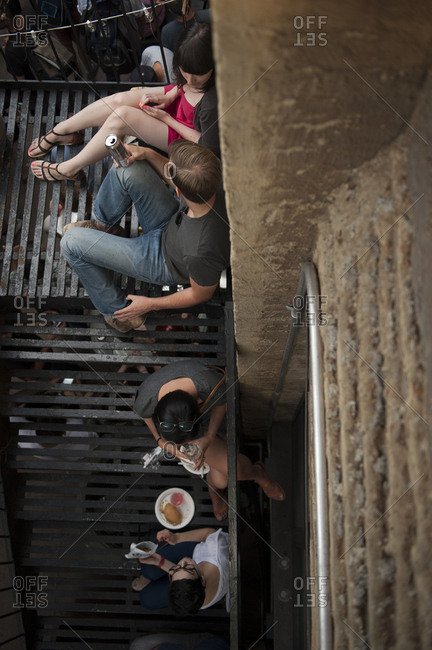 On July 21, 2012 in Brooklyn, New York, crowds of young people gather on a fire escape