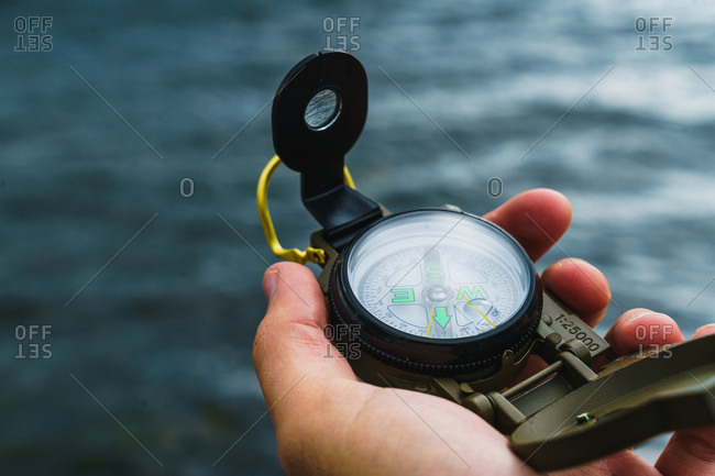 Crop male hand holding compass