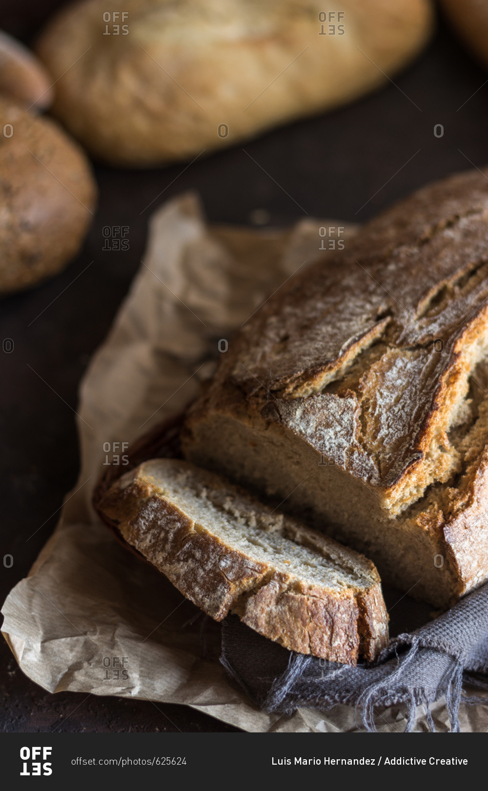 Various types of home-made bread on rustic table