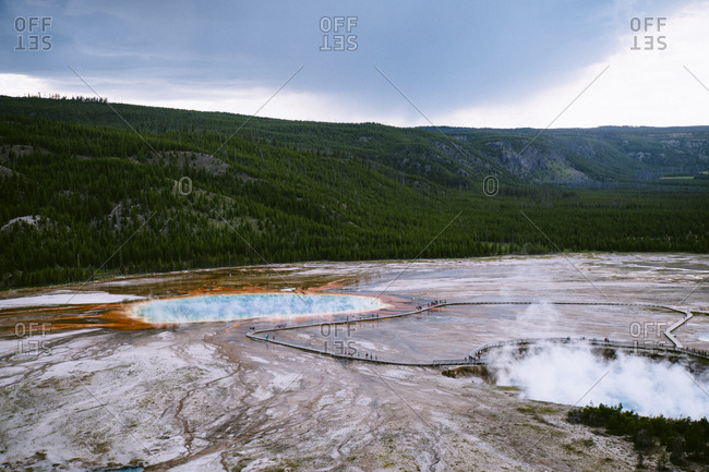 Idyllic view of hot springs by mountains at Yellowstone National Park