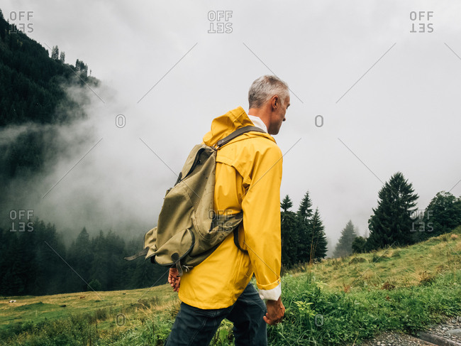 Man mushroom hunting in forested farmland