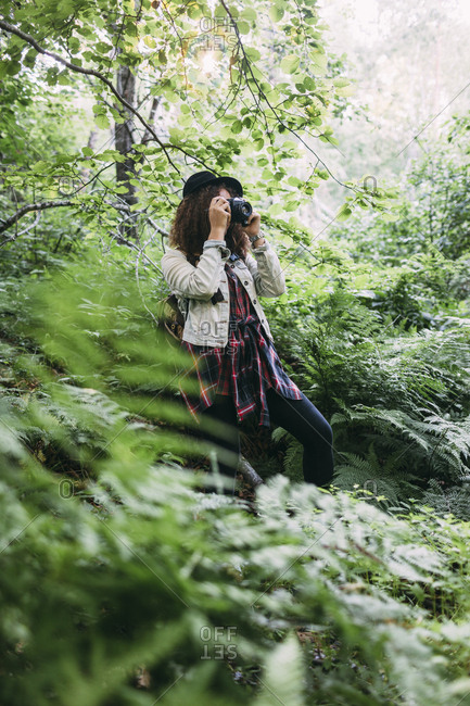 Teenage girl taking pictures in nature