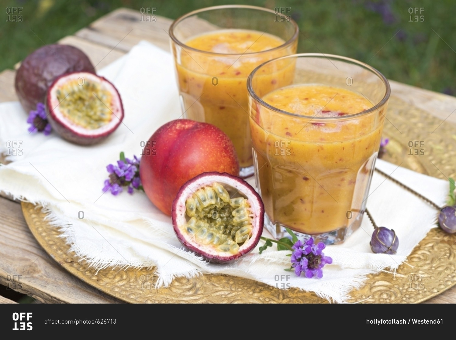 Two glasses of fruit smoothie with passion fruit- nectarine- pomegranate juice and rice milk