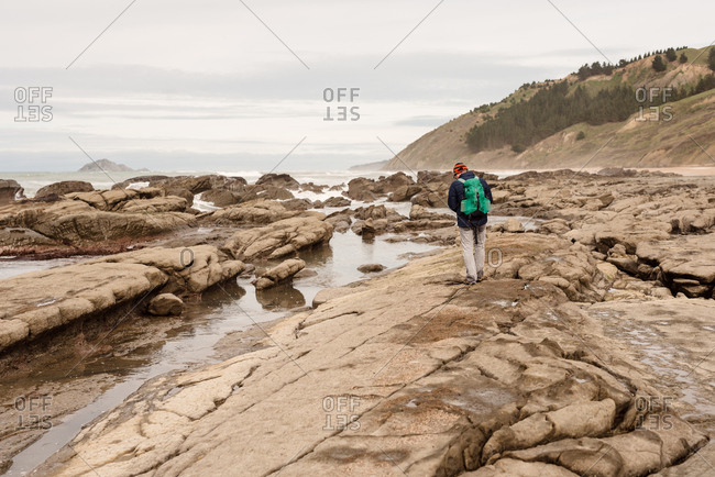 Backpacker hiking on the beach