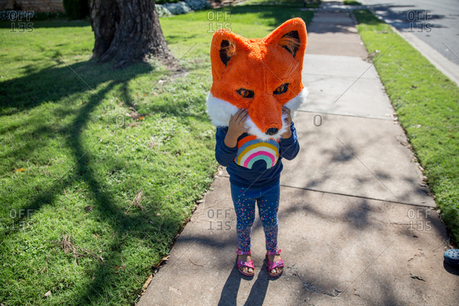 Girl wearing fox mask for Halloween