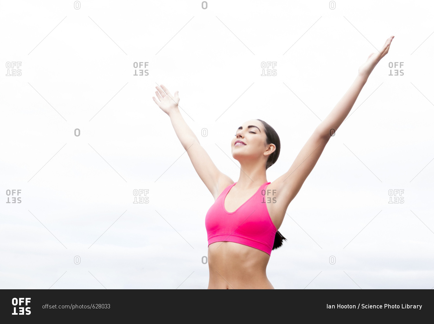Woman wearing sports bra with arms up