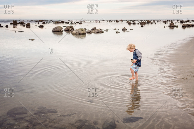 Little boy playing in the ocean shore