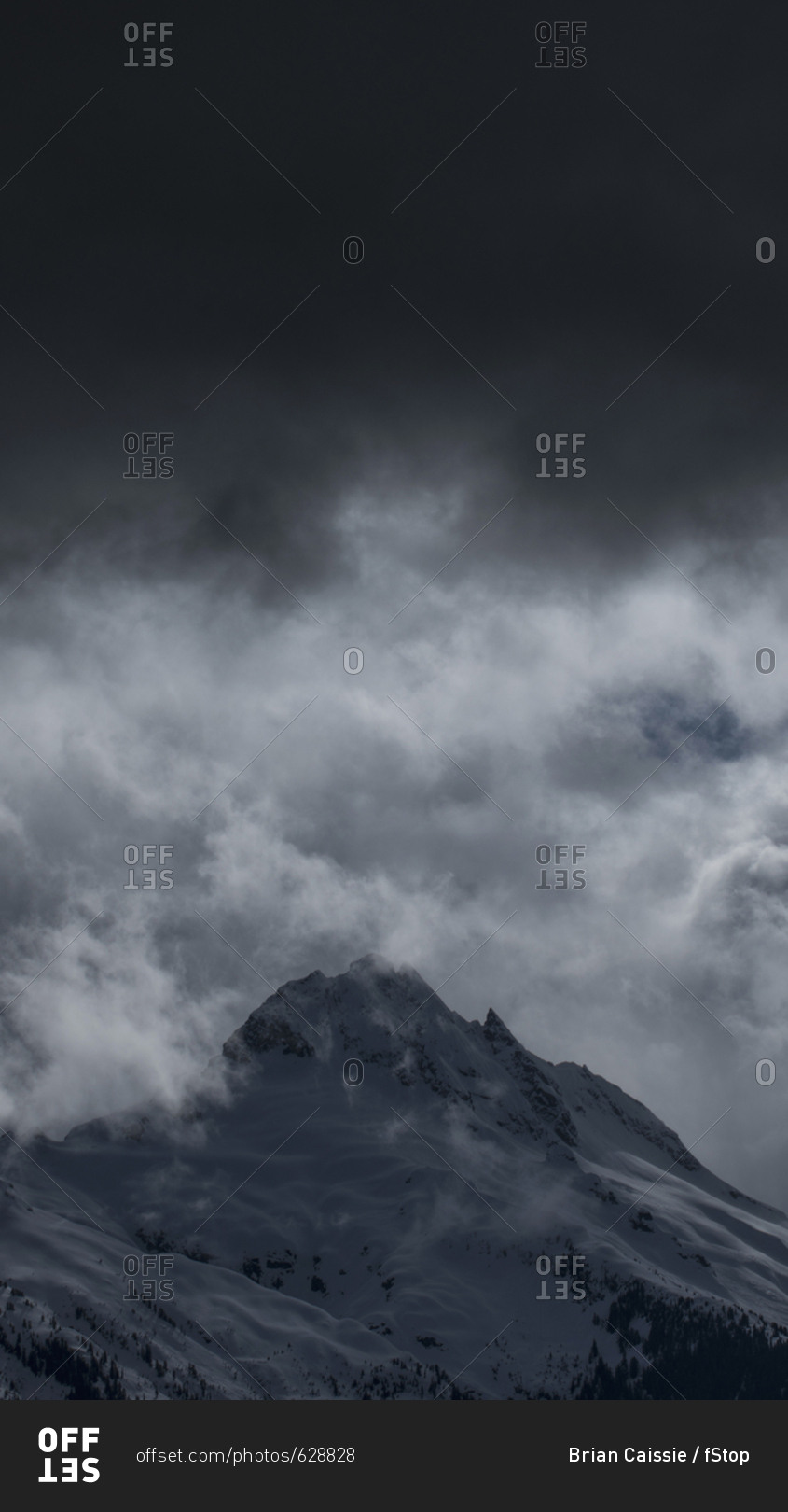 Low angle view of snowcapped mountain against cloudy sky, Tantalus, British Columbia, Canada