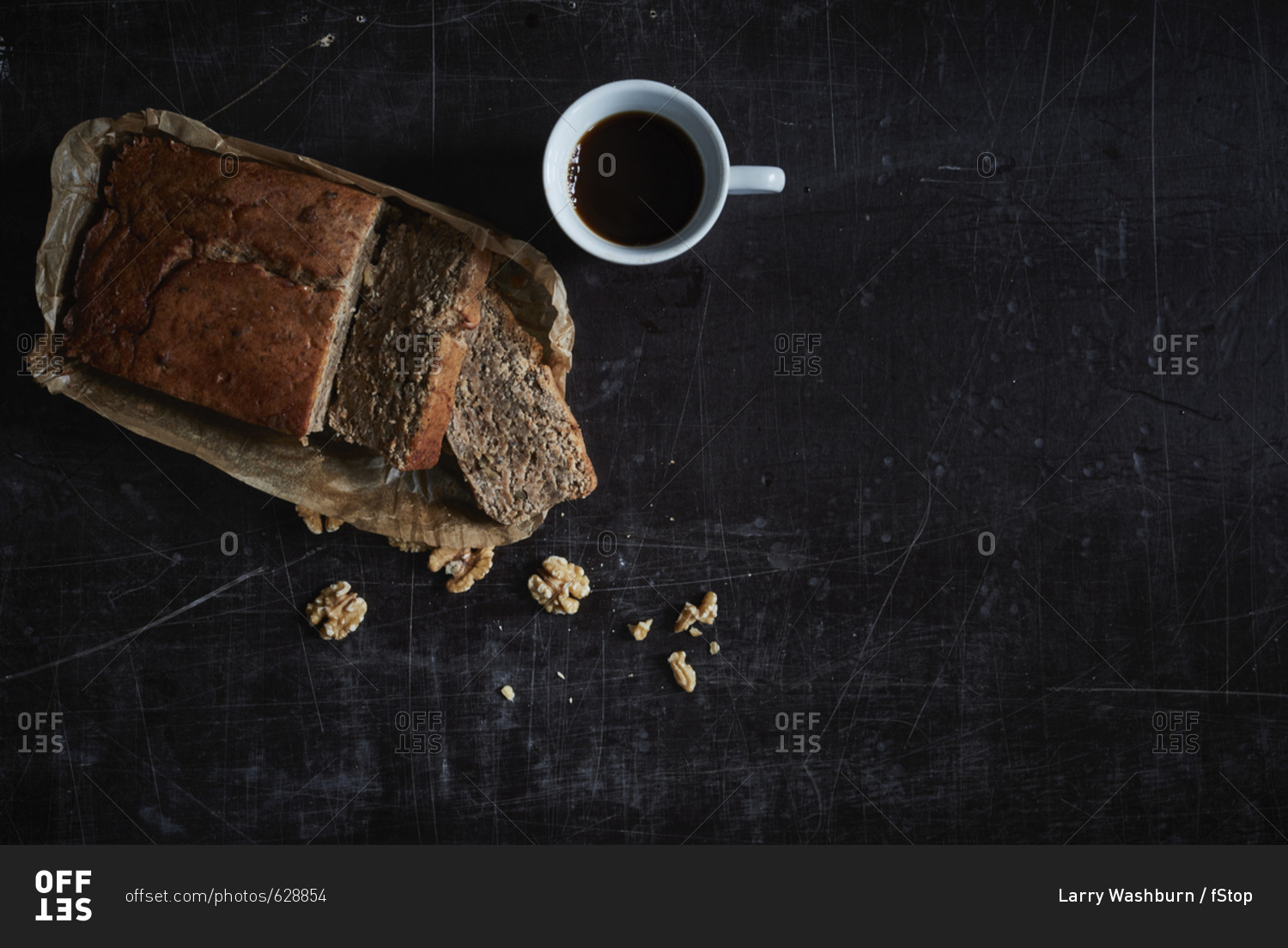Directly above shot of walnut cake with coffee mug on granite