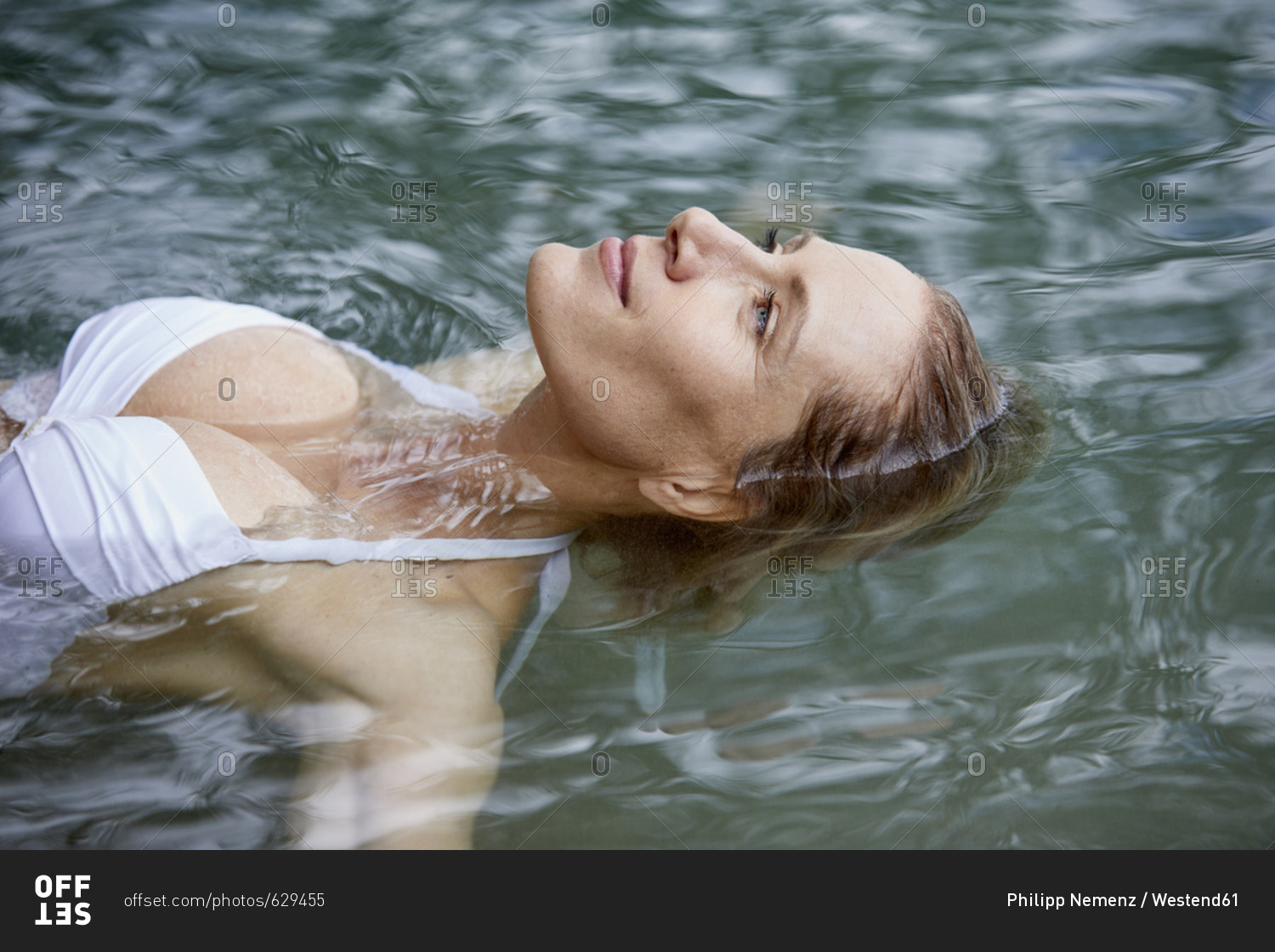 Portrait of relaxed woman floating on water