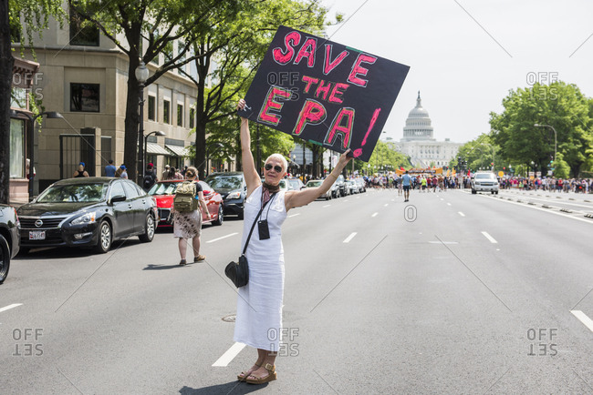 Washington D.C, USA - April 29, 2017: Woman holding "Save the EPA" poster" at The People's Climate March