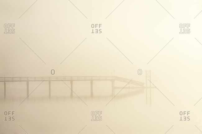 A pier in heavy fog and early morning light, Vancouver Island, British Columbia, Canada