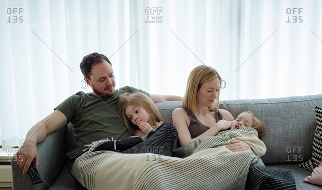 Family relaxing in living room at home