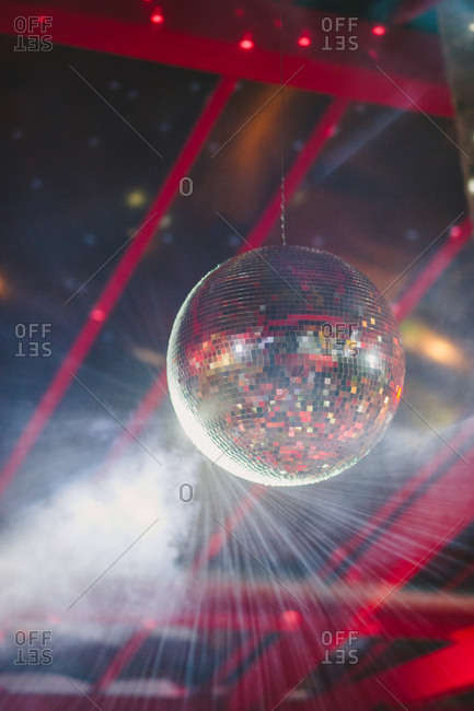 Light reflecting off mirrored disco ball at party