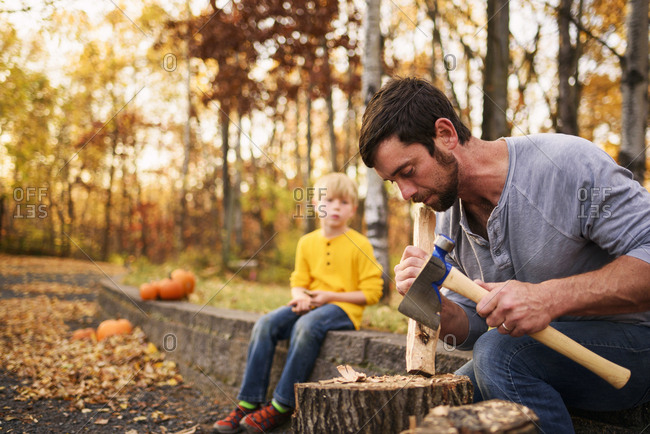 Man and two boys carving wood