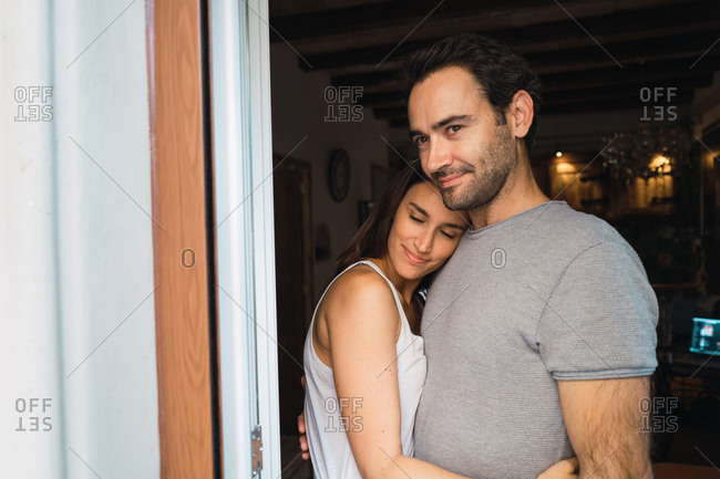 Loving parents embracing at home