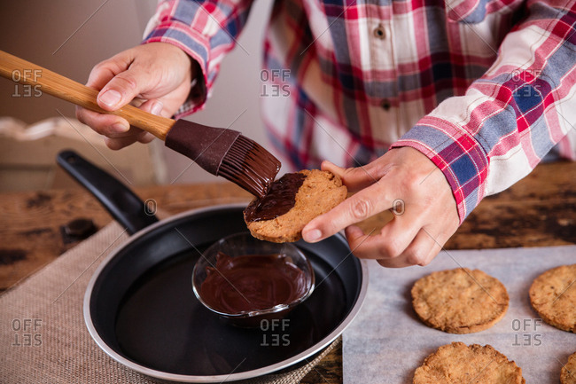 Anonymous Chef Decorating Cookies With Melted Chocolate Using A