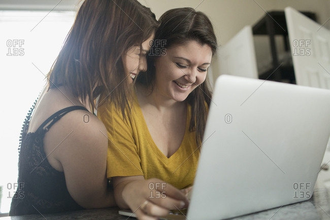 Lesbian couple using laptop together