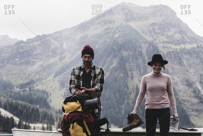 Austria- Tyrol- Alps- couple with backpack and hiking boots in alpine landscape