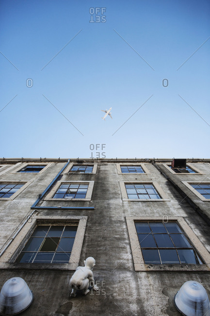 Lisbon, Portugal - June 7, 2016: An artwork of a crawling baby on the fa�ade of an old warehouse in LX factory, which is a creative mini city in an industrial environment.