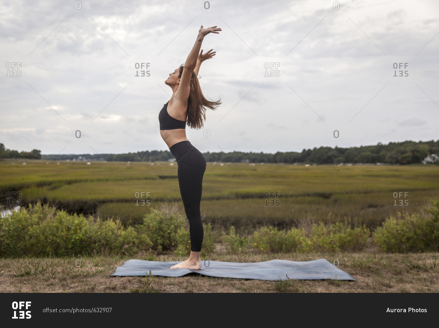 Woman About To Do A Forward Fold Vinyasa Flow Outside On A Yoga Mat