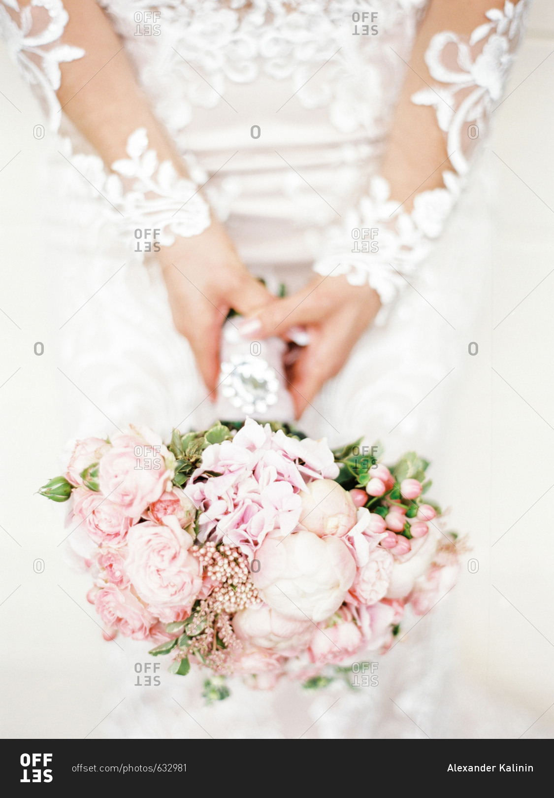 Bride holding wedding bouquet with pink roses