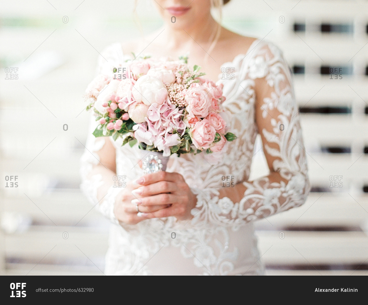 Bride holding wedding bouquet with pink flowers