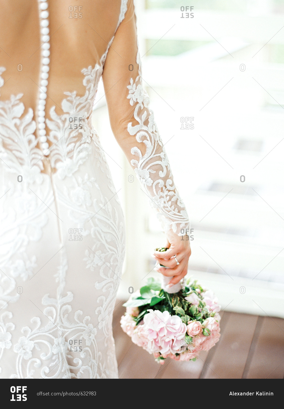 Bride walking away holding bridal bouquet