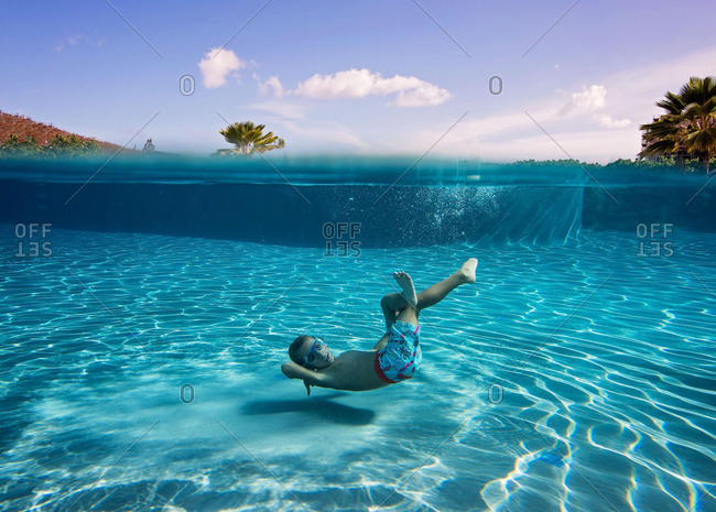 Underwater view of boy swimming in a pool