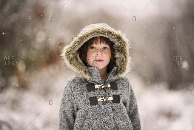 Young girl bundled in a fur coat