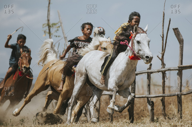 Indonesia, Sumbawa Besar - September 16, 2017: Jockeys riding racehorses during horse racing