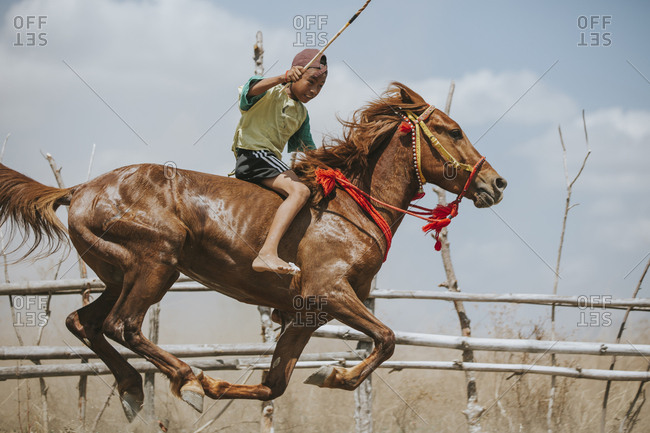 Indonesia, Sumbawa Besar - September 16, 2017: Jockey riding racehorse during horse racing