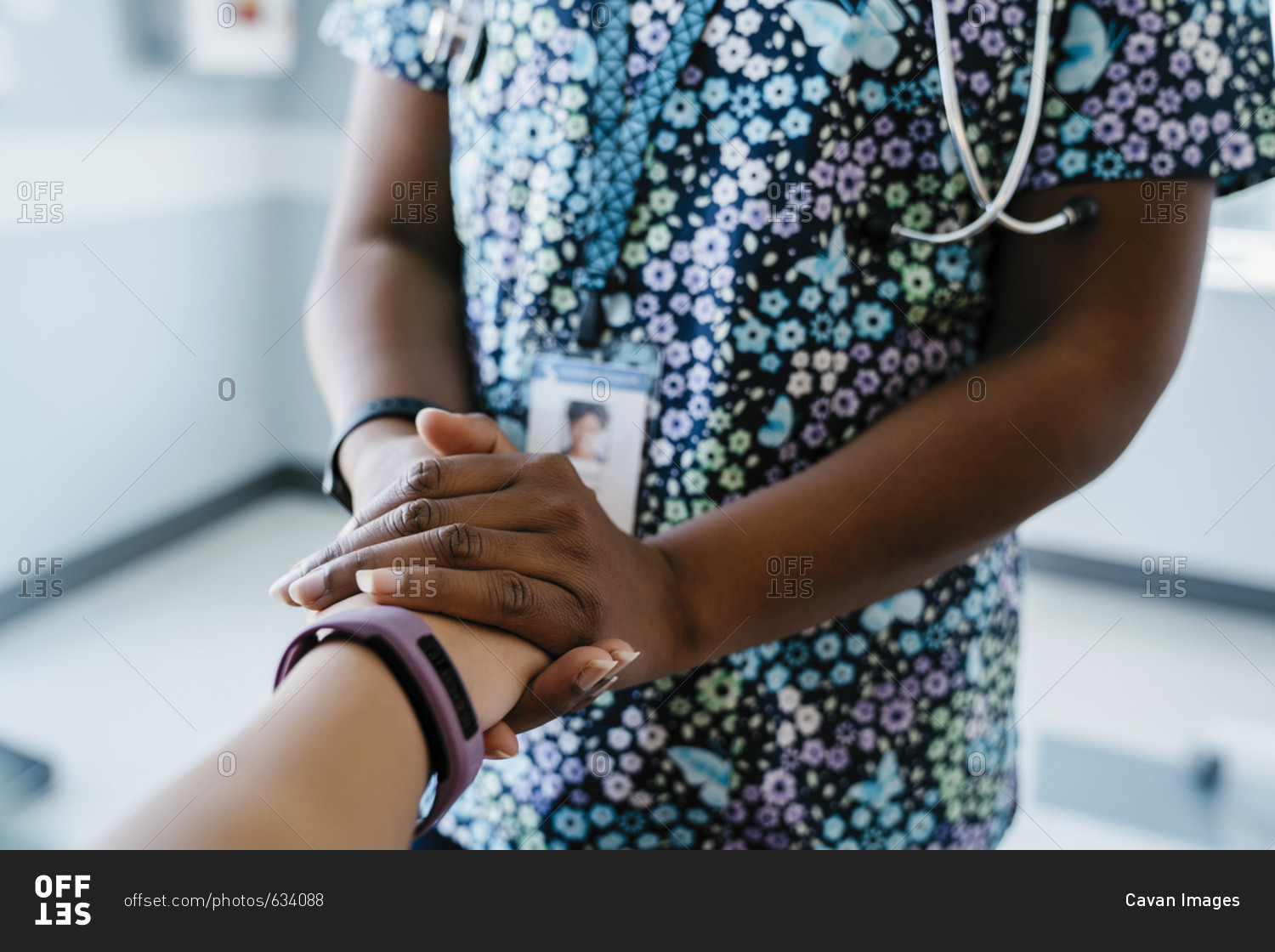 Close-up of pediatrician comforting girl in medical examination room