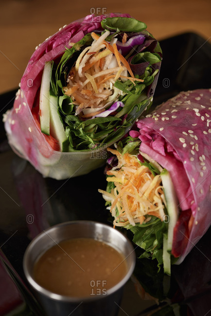 Wrap served in soft rice paper including spinach, carrots, basil leaves, cabbage and served with a sweet peanut sauce on the side