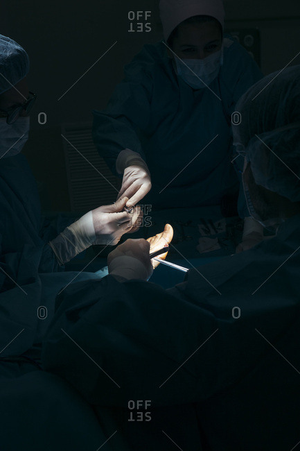 Group of surgeons working with patient