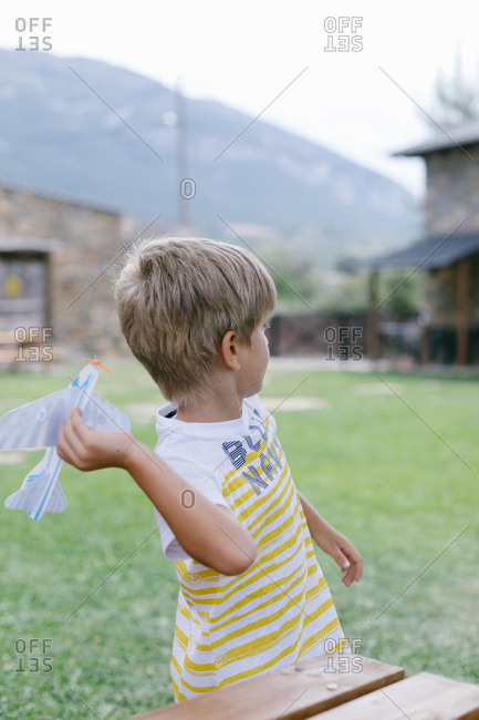 Boy throwing paper plane