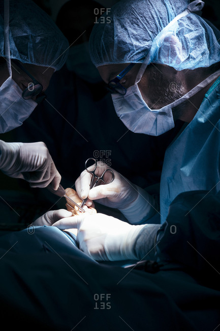 Group of surgeons working with patient