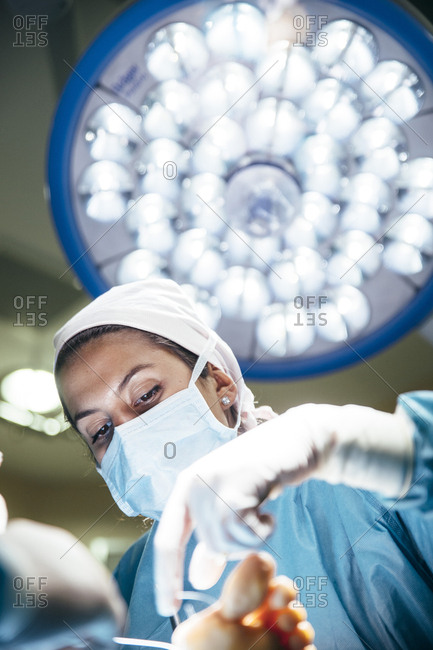 Specialists working with patient in surgery room