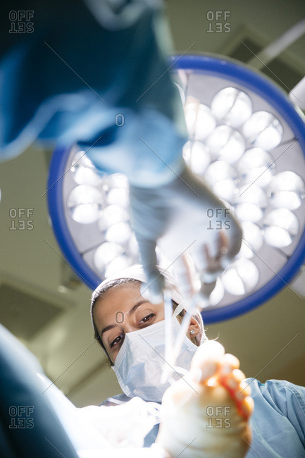 Specialists working with patient in surgery room