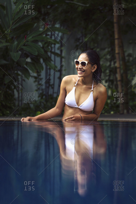 Cambodia, Southeast Asia, Asia - January 17, 2016: Young South East Asian woman in a white bikini in a swimming pool