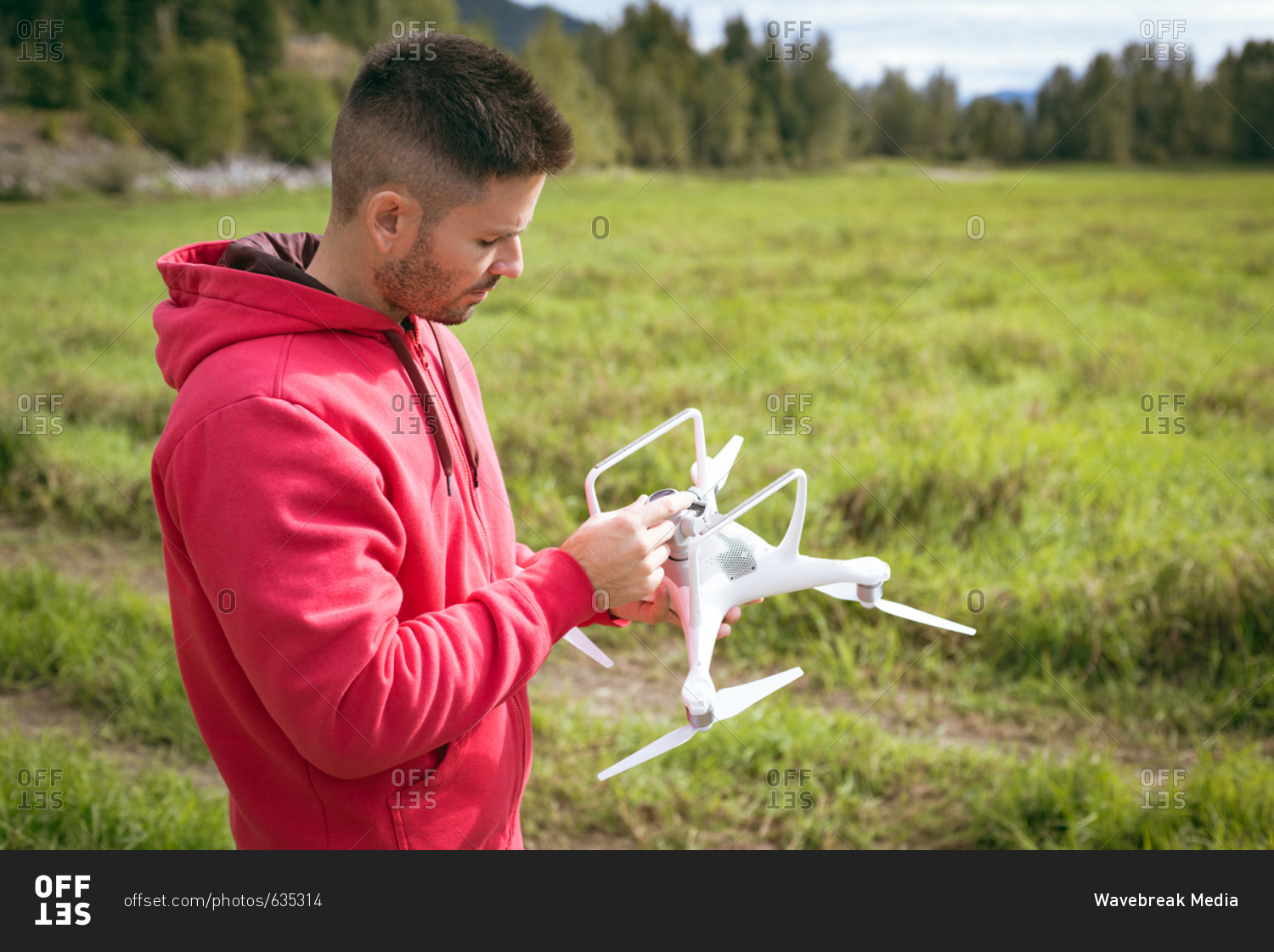 Man adjusting camera on drone before take off