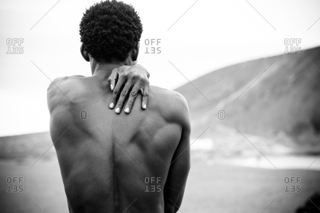 Rear view of muscular black man on a beach