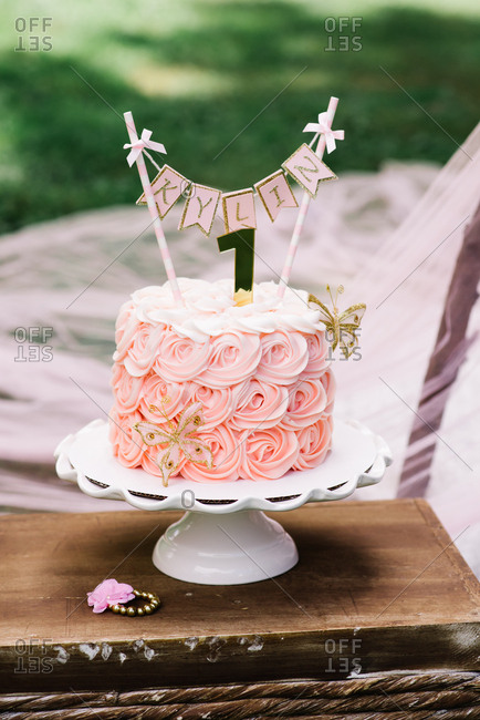 Two tier peach color birthday cake with pearls and white flower patterns.JPG