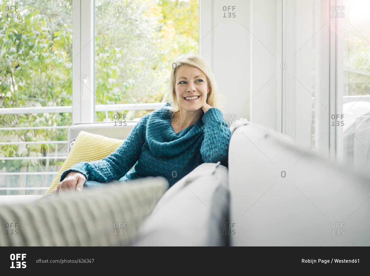 Portrait of happy woman relaxing on couch