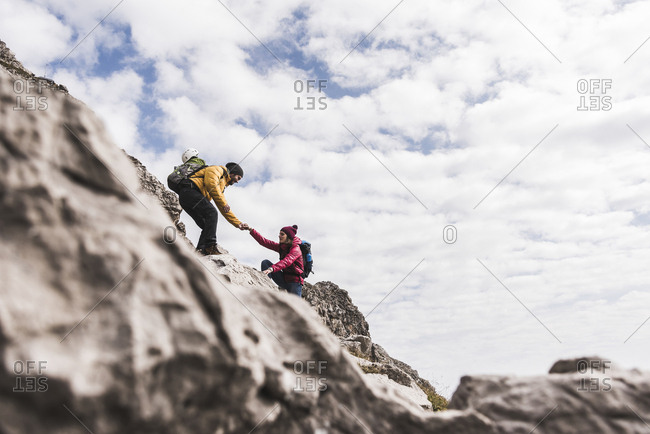 Germany Bavaria Oberstdorf Man Helping Woman Climbing Up Rock Stock Photo Offset